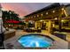 Inviting outdoor hot tub and covered patio with lights create a relaxing backyard retreat at 17363 W Lisbon Ln, Surprise, AZ 85388