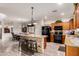 Stylish kitchen featuring an island with stone accents, wood cabinets, and stainless steel appliances at 17363 W Lisbon Ln, Surprise, AZ 85388