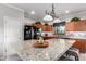Well-equipped kitchen boasts a granite island, black appliances, and ample cabinet space at 17363 W Lisbon Ln, Surprise, AZ 85388