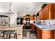 Kitchen with stone backsplash, black appliances, and wooden cabinets, offering a functional design at 17363 W Lisbon Ln, Surprise, AZ 85388