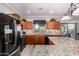Bright kitchen with granite countertops, black appliances, and a view of the outdoor patio at 17363 W Lisbon Ln, Surprise, AZ 85388
