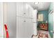 Laundry room with white cabinets, washer, dryer, and tile floor at 17363 W Lisbon Ln, Surprise, AZ 85388