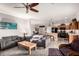 Open-concept living room connects to the kitchen with island seating, creating an inviting space at 17363 W Lisbon Ln, Surprise, AZ 85388