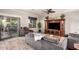 Relaxing living room with a sliding glass door to backyard and entertainment center at 17363 W Lisbon Ln, Surprise, AZ 85388