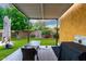 Covered patio with seating area, grill, and view of the landscaped backyard, ideal for outdoor dining at 17363 W Lisbon Ln, Surprise, AZ 85388