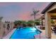 A refreshing pool is surrounded by mature palm trees and luxurious landscaping at 17363 W Lisbon Ln, Surprise, AZ 85388