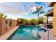 Backyard pool and spa area surrounded by lush landscaping, creating a private outdoor retreat at 17363 W Lisbon Ln, Surprise, AZ 85388