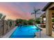 Sparkling swimming pool with waterfall features surrounded by lush landscaping, ideal for relaxation and enjoyment at 17363 W Lisbon Ln, Surprise, AZ 85388