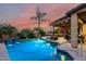 Inviting pool with a waterfall feature, spa, and covered patio creates an outdoor oasis at 17363 W Lisbon Ln, Surprise, AZ 85388