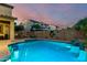 Backyard oasis featuring a stunning pool with a bar, perfect for enjoying warm Arizona evenings at 17363 W Lisbon Ln, Surprise, AZ 85388