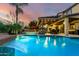 Lush backyard featuring a pool, spa, and covered patio, perfect for outdoor entertaining at 17363 W Lisbon Ln, Surprise, AZ 85388