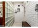 Modern shower with stylish glass block wall, dual showerheads and bench at 17363 W Lisbon Ln, Surprise, AZ 85388