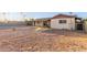 View of a gravel backyard featuring a covered patio and block fence at 1751 W Carol Ave, Mesa, AZ 85202