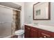 Bathroom features a vanity with granite countertop and a tiled shower with glass door at 1751 W Carol Ave, Mesa, AZ 85202