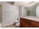 Bathroom featuring a granite countertop, wood cabinets and tile surround in shower at 1751 W Carol Ave, Mesa, AZ 85202