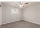 Bright bedroom with neutral walls, carpet and a window letting in plenty of natural light at 1751 W Carol Ave, Mesa, AZ 85202