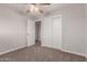 This bedroom features carpet flooring, a ceiling fan, and a closet at 1751 W Carol Ave, Mesa, AZ 85202
