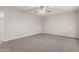 Spacious bedroom featuring neutral carpeting, a ceiling fan, and ample natural light at 1751 W Carol Ave, Mesa, AZ 85202