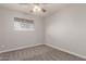 This bedroom features carpet flooring, a window, and neutral colored walls at 1751 W Carol Ave, Mesa, AZ 85202