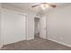 Neutral bedroom featuring a ceiling fan, carpet and a closet for ample storage at 1751 W Carol Ave, Mesa, AZ 85202