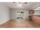 Bright dining area features a ceiling fan, tile flooring, and sliding glass door to the backyard at 1751 W Carol Ave, Mesa, AZ 85202