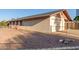Single-story home with a detached garage, low-maintenance rock landscaping, and fenced yard at 1751 W Carol Ave, Mesa, AZ 85202