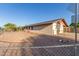 Single-story home with a detached garage, low-maintenance rock landscaping, and fenced yard at 1751 W Carol Ave, Mesa, AZ 85202