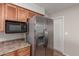 This kitchen showcases stainless steel appliances and wooden cabinetry at 1751 W Carol Ave, Mesa, AZ 85202