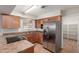 This kitchen features stainless steel appliances, wooden cabinets, and granite countertops at 1751 W Carol Ave, Mesa, AZ 85202