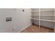 A laundry room with utility connections and built-in shelving at 1751 W Carol Ave, Mesa, AZ 85202