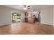Open-concept living area featuring tile flooring, a kitchen view, and a sliding door to outdoor patio at 1751 W Carol Ave, Mesa, AZ 85202