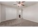 This bedroom offers carpet, ceiling fan, closet, and view to bathroom at 1751 W Carol Ave, Mesa, AZ 85202