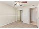Bedroom featuring a ceiling fan, mirrored closet, and a view to the hall at 18402 N 17Th Ave, Phoenix, AZ 85023