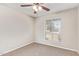 Well-lit bedroom with neutral carpet and a window offers a tranquil space for rest and relaxation at 18402 N 17Th Ave, Phoenix, AZ 85023