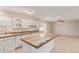 Updated kitchen with island, tile countertops, and white cabinetry offers a clean, modern aesthetic at 18402 N 17Th Ave, Phoenix, AZ 85023