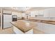 Well-equipped kitchen boasts white appliances, tile countertops, and a functional island for meal prep at 18402 N 17Th Ave, Phoenix, AZ 85023