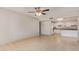 Open-concept living room flows into the kitchen with bright white cabinets at 18402 N 17Th Ave, Phoenix, AZ 85023