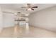 Open-concept living room flows into the kitchen with bright white cabinets at 18402 N 17Th Ave, Phoenix, AZ 85023