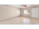 Bright living room features tile floors, a ceiling fan, and a large window at 18402 N 17Th Ave, Phoenix, AZ 85023