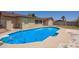 Inviting pool with blue tiles and surrounding concrete patio beside the beige stucco house at 18402 N 17Th Ave, Phoenix, AZ 85023