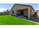 The backyard features lush artificial grass and a relaxing covered patio at 18808 W Solano Dr, Litchfield Park, AZ 85340