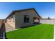 A well-maintained backyard includes green grass and a covered patio at 18808 W Solano Dr, Litchfield Park, AZ 85340