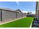 Artificial turf backyard, perfect for low maintenance with high block fence at 18808 W Solano Dr, Litchfield Park, AZ 85340