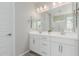 Bright bathroom featuring a double sink vanity with modern fixtures and a large mirror at 18808 W Solano Dr, Litchfield Park, AZ 85340