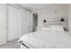 Light-filled bedroom featuring a bed with a decorative headboard and a sliding closet door at 18808 W Solano Dr, Litchfield Park, AZ 85340