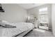 Well-lit bedroom with neutral tones featuring a bed, dresser, and bookshelf at 18808 W Solano Dr, Litchfield Park, AZ 85340