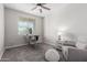 Bright room featuring a ceiling fan, a desk, and a chair by the window at 18808 W Solano Dr, Litchfield Park, AZ 85340