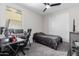 Bedroom featuring a desk, bed, ceiling fan, and carpet flooring at 18808 W Solano Dr, Litchfield Park, AZ 85340