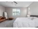 Bright bedroom showcasing plush carpeting, natural light, and cozy seating at 18808 W Solano Dr, Litchfield Park, AZ 85340