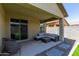 Relaxing covered patio area features an outdoor seating area with a view at 18808 W Solano Dr, Litchfield Park, AZ 85340